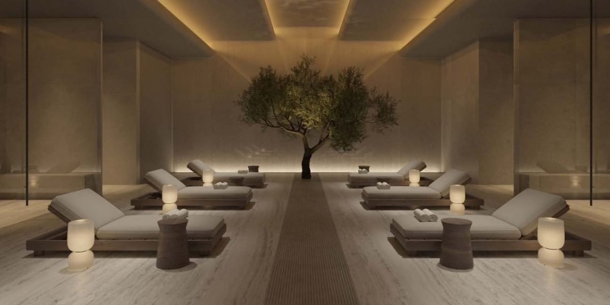 The relaxation lounge at Akala Spa, with heated loungers set around an olive tree.