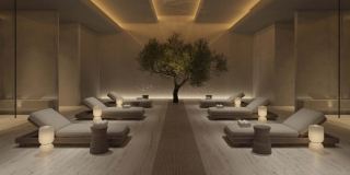 The pool hall in the spa at Akala, in stone with loungers along the water.