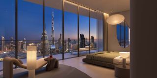 A bedroom at Akala facing the Burj Khalifa through full-height glass.