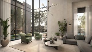 Living space in an Athlon Premium villa with double-height glazing to the garden.