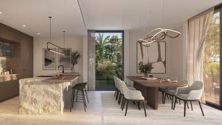 Kitchen island and dining area in an Athlon Premium villa.