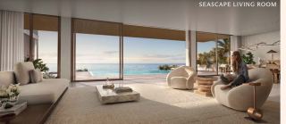 Living room of a Y Views villa framing the pool and open sea through sliding glazing.