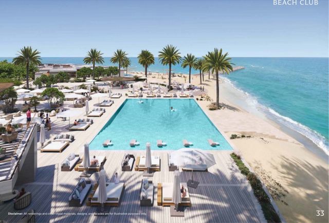 The beach club at Y Views, BAYN Ghantoot, with pool, loungers and palms on the Arabian Gulf shoreline.