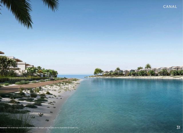 The canal at Y Views, with villas lining a sand-edged waterway that opens to the sea.