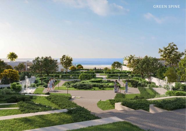 The pedestrian green spine at Y Views, a landscaped promenade running from the hilltop down to the beach.