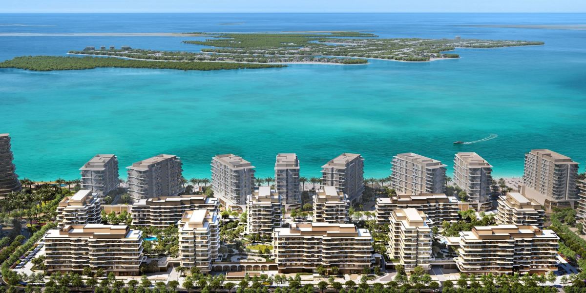The Beach House Fahid from above, its eleven towers on the podium with the beach and the mangroves beyond.