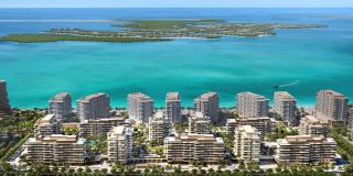 The Beach House Fahid from above, its eleven towers on the podium with the beach and the mangroves beyond.