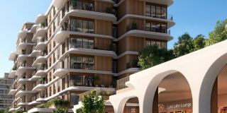 The podium colonnade at The Beach House Fahid, with its arches and the towers above.