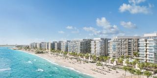 The beach frontage at Fahid Beach Residences, with the buildings set along the shoreline.