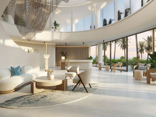 The residential lounge at Fahid Beach Terraces, lit from the shoreline side.