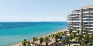 The six towers of Fahid Beach Terraces along the shoreline of Fahid Island.