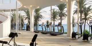 The gymnasium in the Clubhouse at Fahid Beach Terraces, with waterfront views.