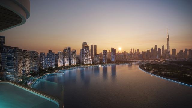 Sunset over the water at Dubai Design District, with the Burj Khalifa on the horizon