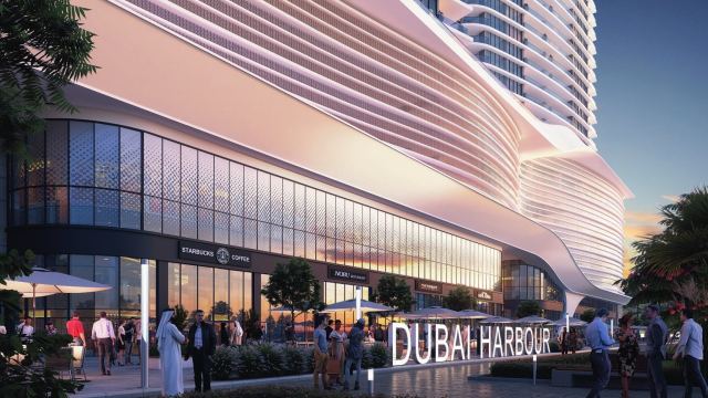 The promenade at Dubai Harbour, restaurants along the water below the towers