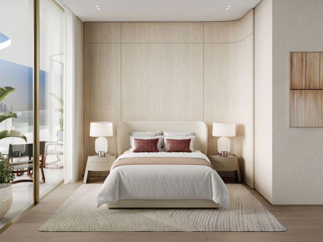 Secondary bedroom at Dubai Harbour Residences with full-height glazing.