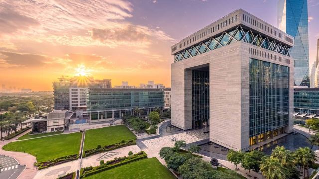 The Gate Building at DIFC on its lawn at sunrise