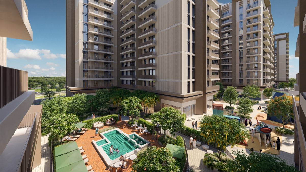 Aerial view of Expo Valley Views apartment buildings around a landscaped pool courtyard at Expo City Dubai