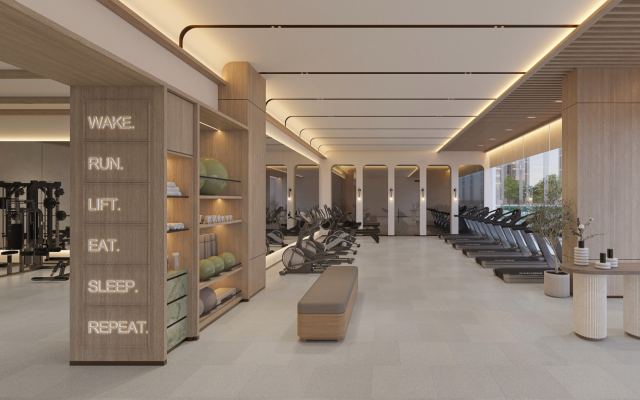 Main gym at Expo Valley Views with cardio equipment and floor-to-ceiling glazing