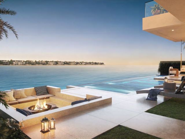 Sunken fire-pit terrace beside the water at a Frond F villa.