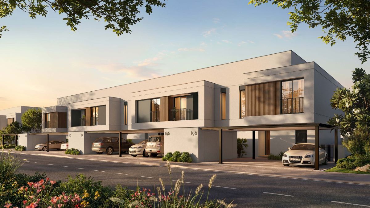 Townhouses on a residential street at Al Ghadeer Gardens by Aldar.
