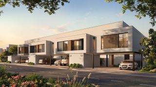 Townhouses on a residential street at Al Ghadeer Gardens by Aldar.