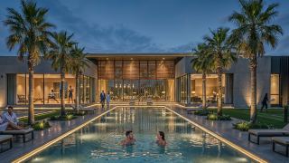 The community centre and swimming pool at Al Ghadeer Gardens in the evening.