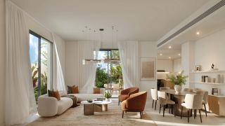 Living and dining space opening to the garden at Al Ghadeer Gardens.