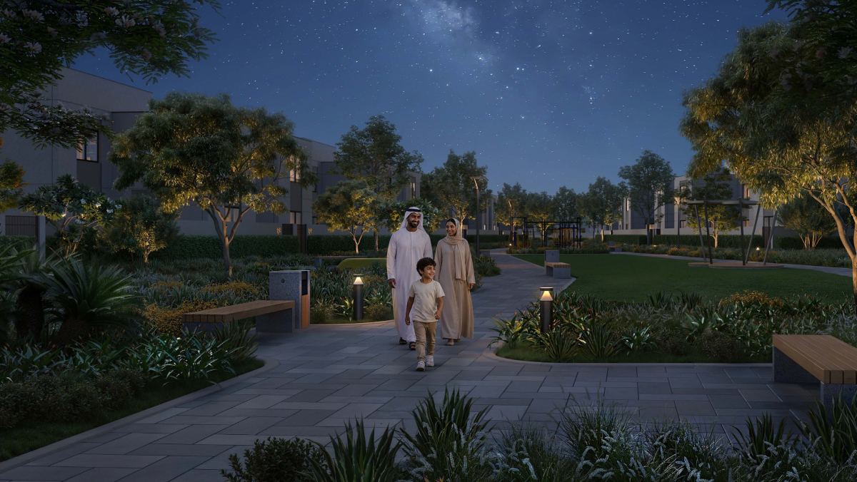 A shaded walkway at Al Ghadeer Gardens in the evening.