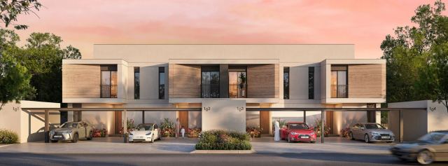 A row of townhouses at Al Ghadeer Parks at dusk.