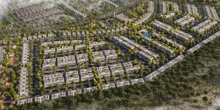 Al Ghadeer Parks from above, the townhouse streets set among parks and tree-lined pathways.