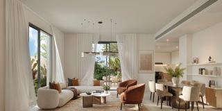 Living and dining room in a townhouse at Al Ghadeer Parks, opening to the garden.