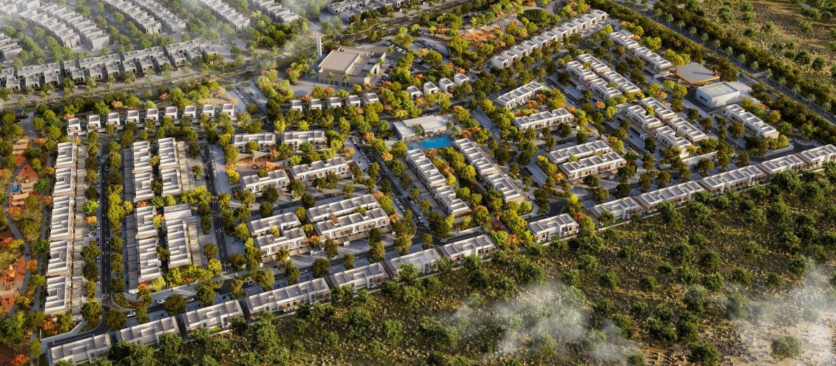The two phases of Al Ghadeer Parks from the air, with the parks running between the streets.
