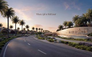 Entrance of The Heights Country Club & Wellness by Emaar in Dubai South, under the tagline 'Where Life is Well-Lived'.