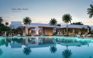 Community swimming pool surrounded by landscaping at The Heights Country Club & Wellness.