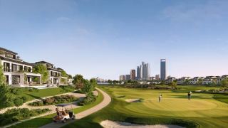 Golf-front villas at Hudayriyat Golf Estates overlooking a fairway, with the Abu Dhabi skyline in the distance.