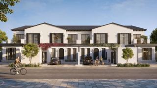 Row of Golf Townhomes at Hudayriyat Golf Estates along a tree-lined street.