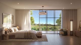 Master bedroom at Hudayriyat Golf Estates with floor-to-ceiling glazing overlooking the golf course.