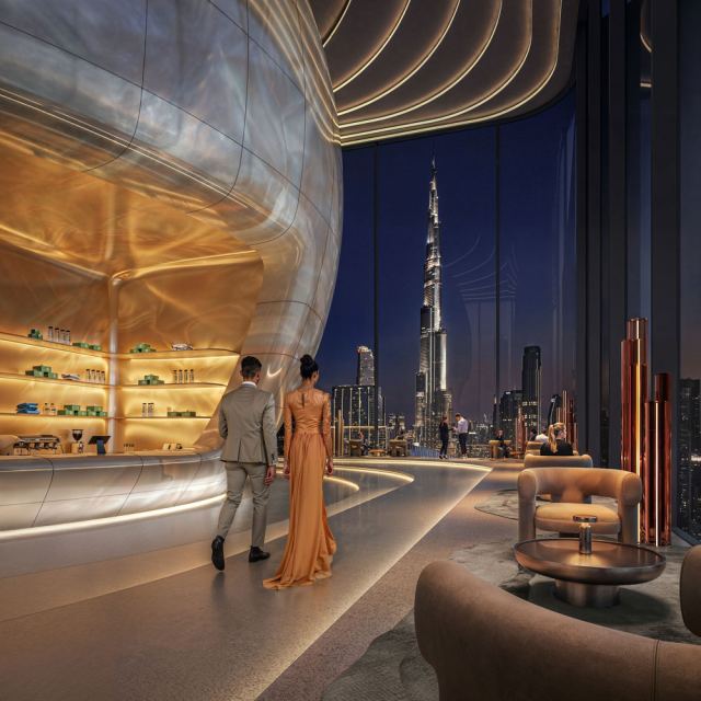 Sky club at Inaura with a sculpted bar and the Burj Khalifa beyond.