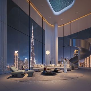 Double-height living space in the Sky Penthouse at Inaura with a spiral stair.