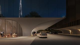 Car arriving under the arched plinth at the entrance to Inaura.