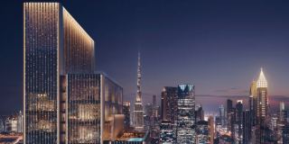 Jumeirah Residences Emirates Towers at dusk, with the Burj Khalifa and Downtown Dubai behind.