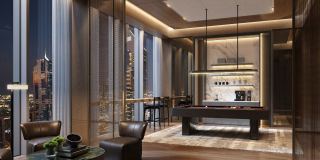 Double-height living room in a three-bedroom residence, wrapped in floor-to-ceiling glass.