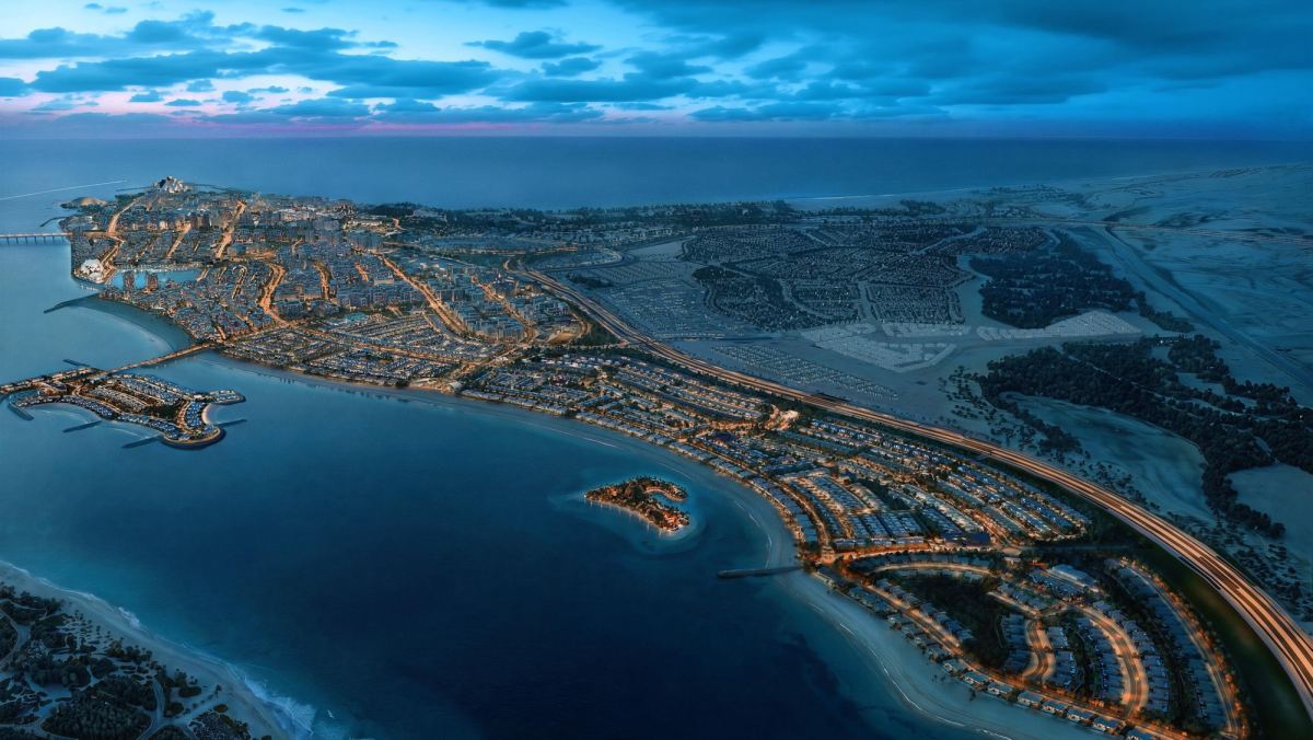 Aerial view of Marsa Al Saadiyat at dusk, showing the marina, the coastline and the lit neighbourhoods behind it.