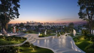 Central Park at Marsa Al Saadiyat at dusk, with water features, sculpture and the Abu Dhabi skyline on the horizon.