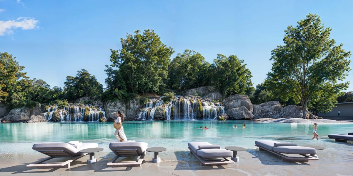 The swimmable forest lagoon at Masaar 3, with landscaped waterfalls and sun loungers.