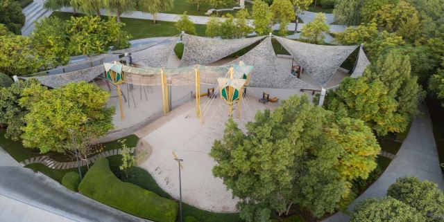 Kids' adventure playground at Masaar 3, with shade canopies and climbing frames.