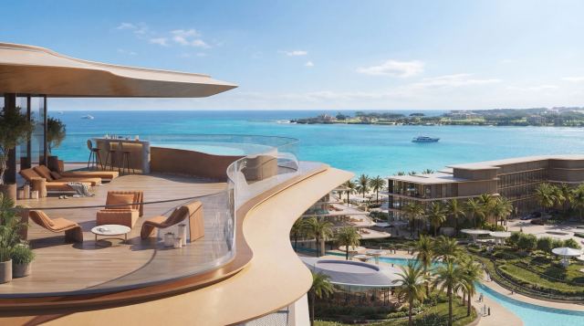 Curved penthouse terrace at The Meriva Collection at dusk, with the enclave pools below.