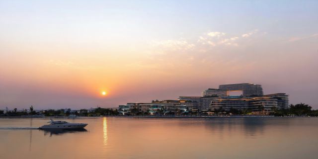 The Meriva Collection seen from the water at sunset, Dubai Islands.