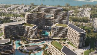 Exterior view of the pedestrianised enclave at The Meriva Collection, with lagoon pools between the residential buildings.