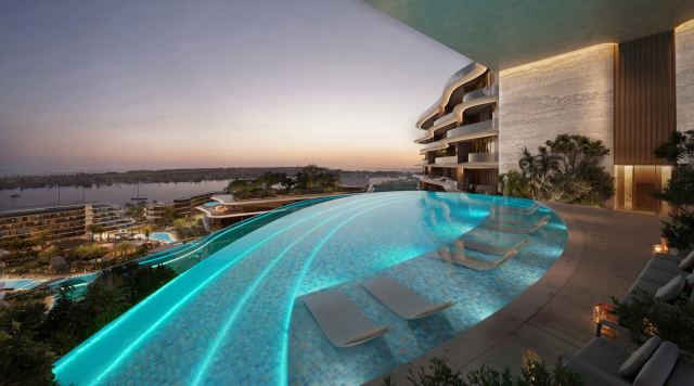 The elevated adults infinity pool at The Meriva Collection at sunset, looking over Dubai Islands.